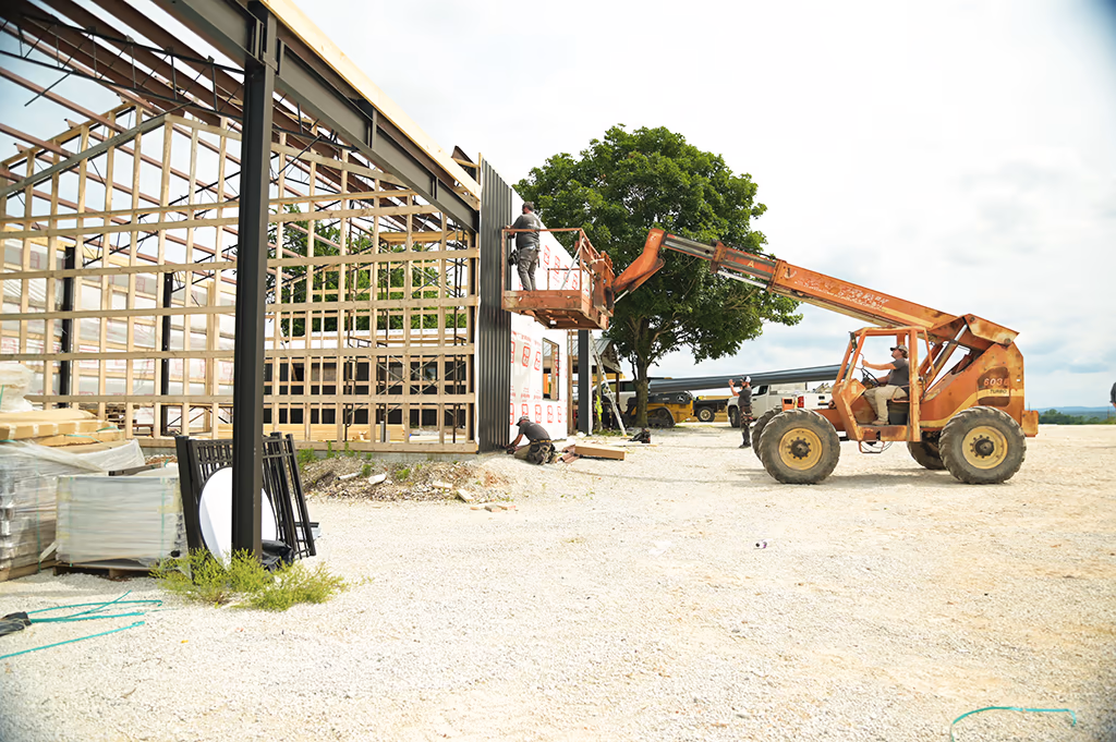 An Integrity Contracting crew working on a metal building frame on a job site near Harrison, Arkansas